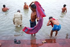 Morning bathing at the Mallick Ghat on Hooghly River in Kolkata, India.