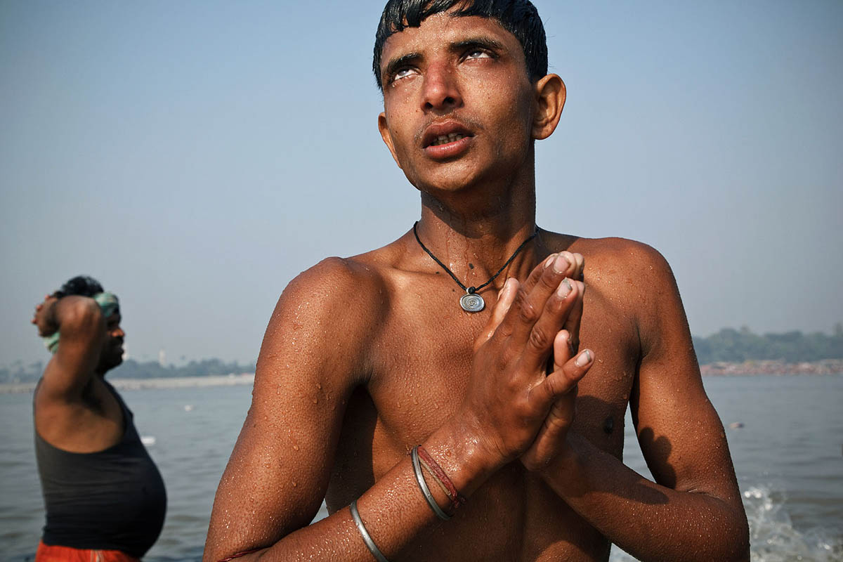 A young man in trance performs religious rituals in Gandak River during Sonepur Mela.